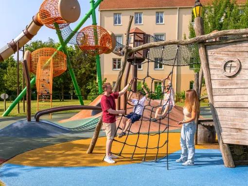 Family enjoying the outdoor play area at Explorers Hotel Marne-la-Vallée