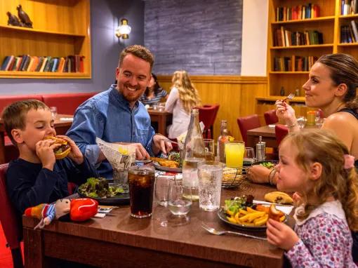 Family enjoying dinner at Explorers Hotel Marne-la-Vallée