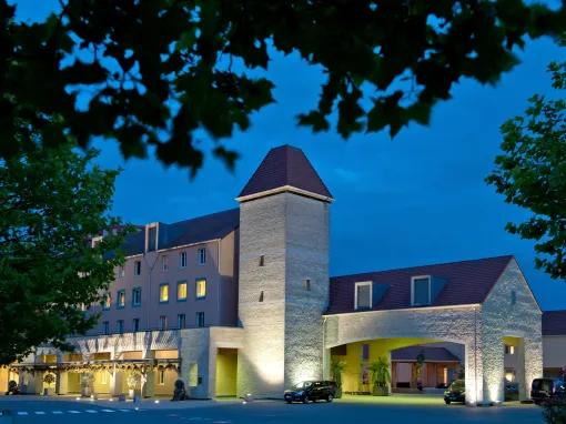 Explorers Hotel Marne-la-Vallée front exterior at night