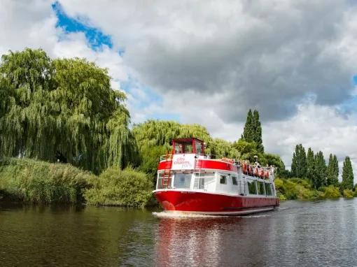 boat-going-past-riverbank