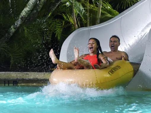 Guests on water slide, Disney H2O Glow Nights at Disney’s Typhoon Lagoon