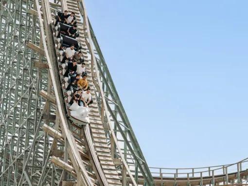 People smiling having fun on Hala Madrid: The Coaster at Real Madrid World Dubai. 