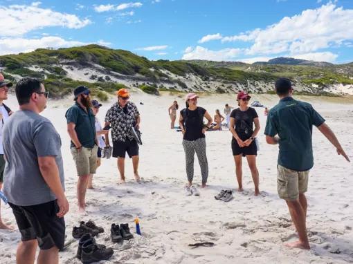 Guide leading the tour group along the iconic Squeaky Beach