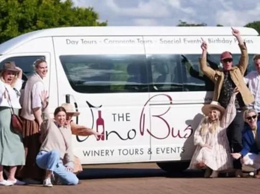 Group of happy people posing in front of The Vino Bus during the Explore Tamborine Tour