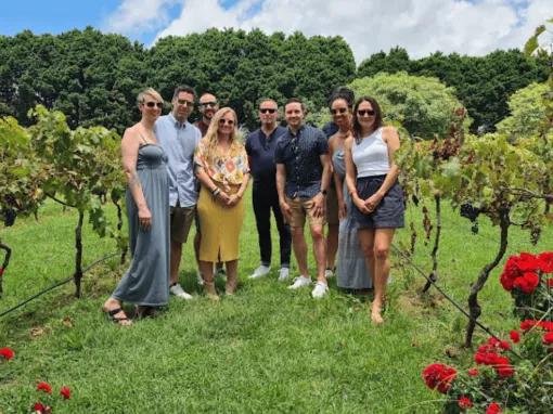 Happy tour group enjoying a winery visit on the Explore Tamborine Tour