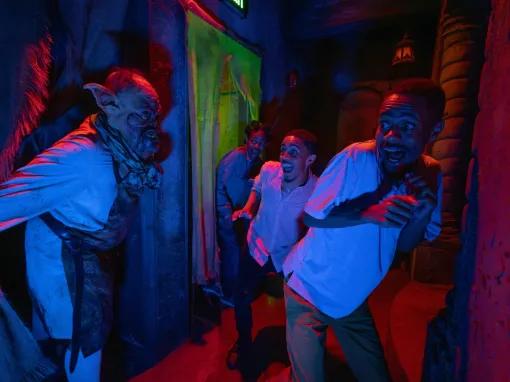 Guests in a scare house at Universal Orlando Halloween Horror Nights