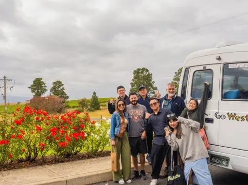Happy group posing with Go West Tours van
