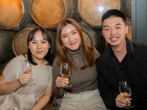Three people enjoying themselves while holding wine glasses at Rochford Wines