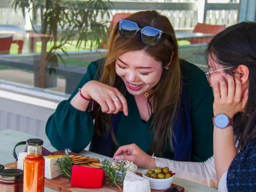 Two women enjoying local food on the Yarra Valley Grazing Tour
