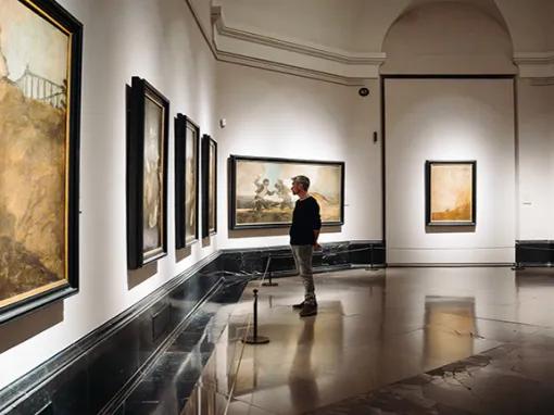 Man looking at art in the Prado