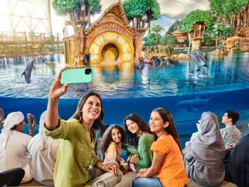 Smiling people taking a selfie at the Dolphin Presentation at SeaWorld Yas Island Abu Dhabi