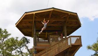 Guest riding the Screamin' Gator Zip Line at Gatorland Orlando