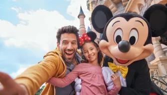 Family with Mickey in front of Sleeping Beauty Castle at Disneyland Paris