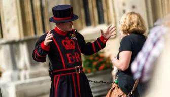 Guest listening to stories from the Beefeaters at Tower of London