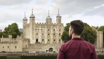 Man viewing Tower of London from across the river