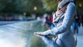 Woman at the Reflecting Pools at the 911 Memorial Museum in New York City