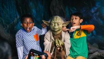 2 boys having their photo taken with Yoda at Madame Tussauds London