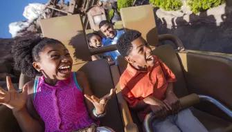 Boy and girl riding Expedition Everest - Legend of the Forbidden Mountain at Disney's Animal Kingdom