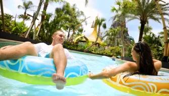 Girls relaxing on Kopiko Wai Winding River at Universal's Volcano Bay Water Theme Park