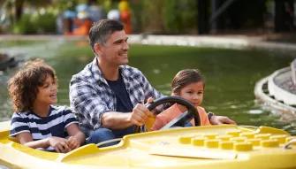 Father driving kids in a boat on Coast Guard HQ at LEGOLAND Windsor