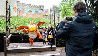 Kids taking photo with Zog the loveable dragon at Warwick Castle