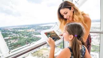 A lady and a young girl on the The Wheel at ICON Park™