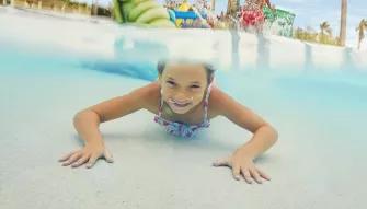 Girl swimming underwater at PortAventura Caribe Aquatic Park