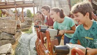 Guests using your water cannons to shoot at pythons on Angkor ride at PortAventura theme park