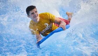 Man riding a wave on Surf's Up at Aquaventure Dubai