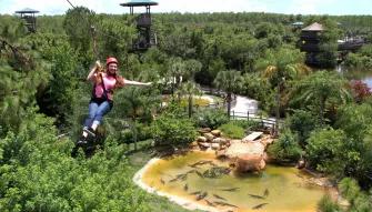 woman riding the Screamin’ Gator Zip Line at Gatorland