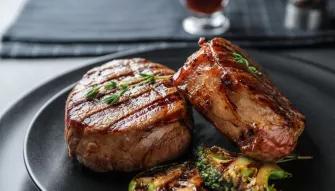 Two steak filets on a plate with grilled green vegetables