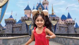 Girl in front of Sleeping Beauty Castle, Disneyland Park in California