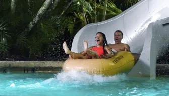 Guests on water slide, Disney H2O Glow Nights at Disney’s Typhoon Lagoon
