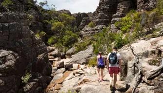 Grampians National Park Day Tour Two people walking through Grand Canyon