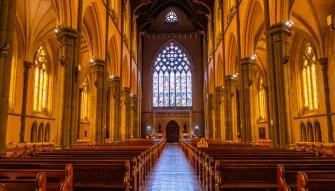 Interior view of St Patrick’s Cathedral with vaulted ceilings and stained glass, taken during the Melbourne City Discovery Tour
