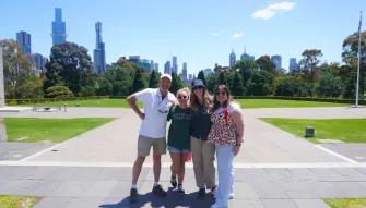 Melbourne City Discovery Tour Tour guide with a group of smiling guests during the Melbourne City Discovery Tour