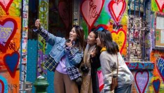 Melbourne City Discovery Tour Three happy ladies snap a selfie in Melbourne’s famous Hosier Lane