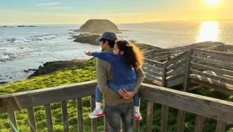 Phillip Island Express Tour Father carrying child on his back while watching the sunset over the Nobbies coastline