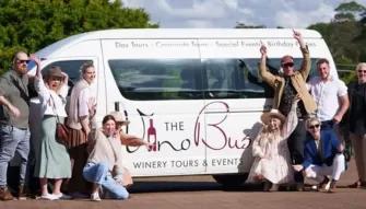 Explore Tamborine Tour Group of happy people posing in front of The Vino Bus during the Explore Tamborine Tour