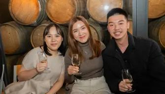 Three people enjoying themselves while holding wine glasses at Rochford Wines