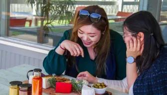 Two women enjoying local food on the Yarra Valley Grazing Tour