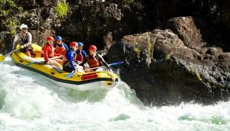 Barron River Rafting A raft full of people navigating a small drop on the Barron River during white water rafting