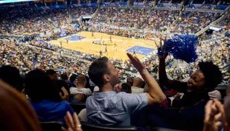 Orlando Magic Close-up of two fans high-fiving and enjoying themselves in a lively, packed Orlando Magic stadium