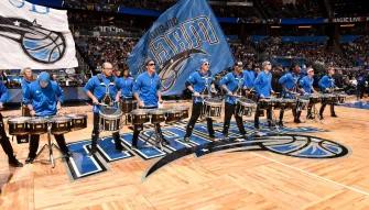 Orlando Magic Drumline performing with big flags on the court at an Orlando Magic game