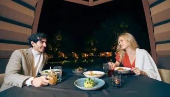 Couple enjoying a romantic dinner on the Platinum Desert Safari