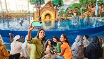 SeaWorld Yas Island Abu Dhabi Smiling people taking a selfie at the Dolphin Presentation at SeaWorld Yas Island Abu Dhabi