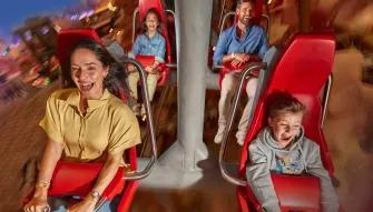 Warner Bros. World Abu Dhabi Guests enjoying the Fast and Furry-ous Roller Coaster at Warner Bros. World Abu Dhabi, smiling and having fun