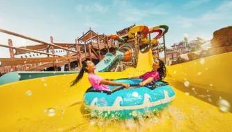 Yas Waterworld Abu Dhabi Friends laughing as they float down a tube slide at Yas Waterworld Abu Dhabi