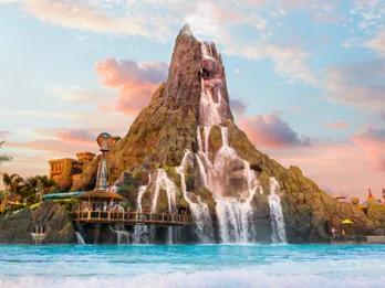 Universal Volcano Bay Water Park A large volcano spilling water into a water park wave pool