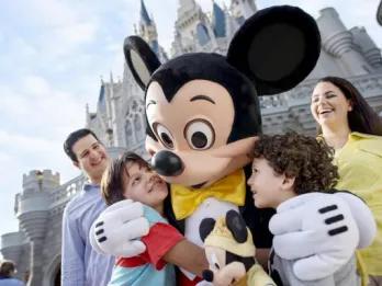 children hugging mickey mouse